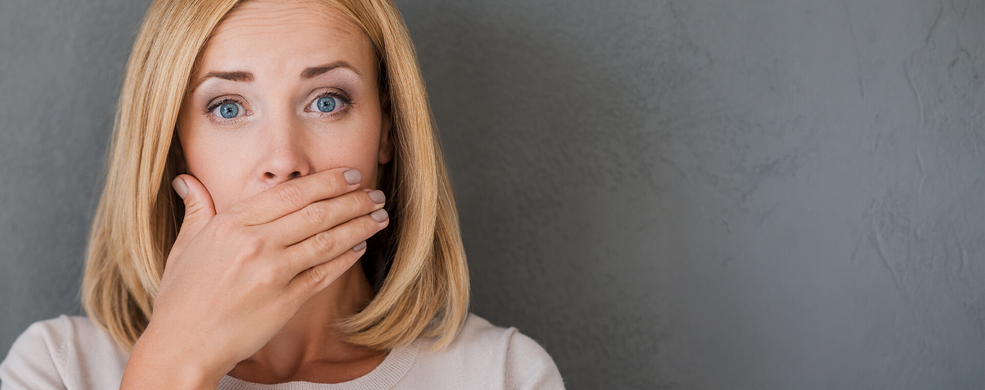 woman covering mouth