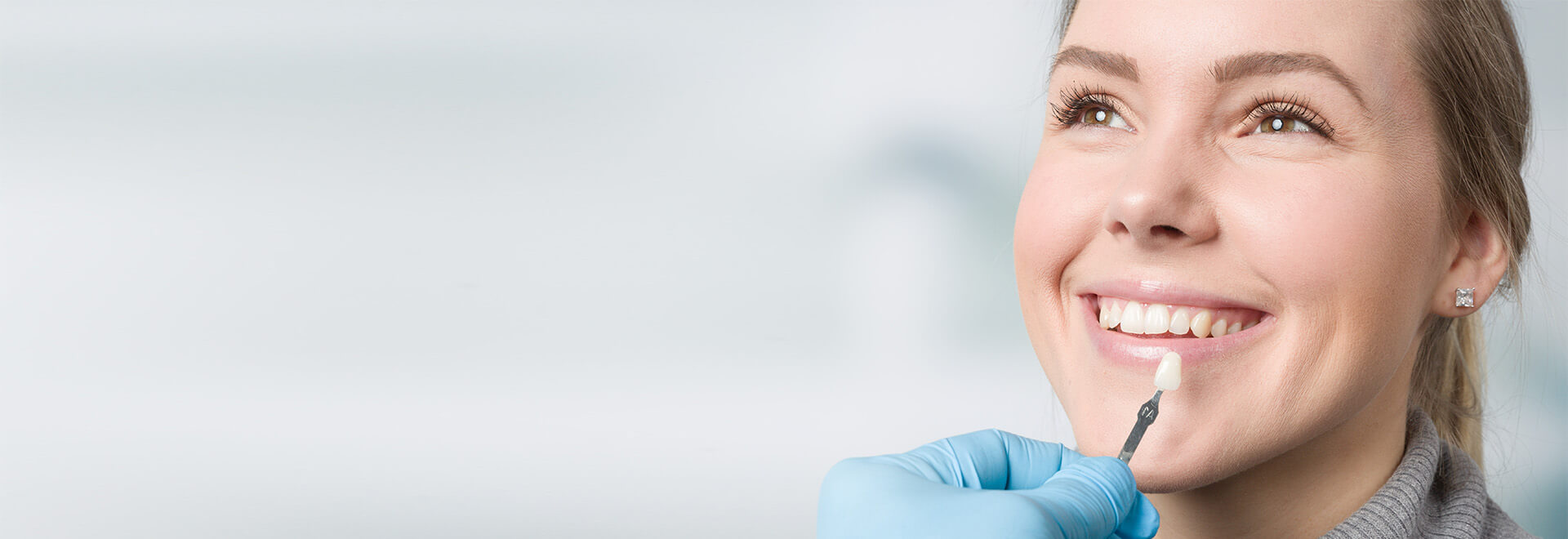 dentist comparing tooth colors