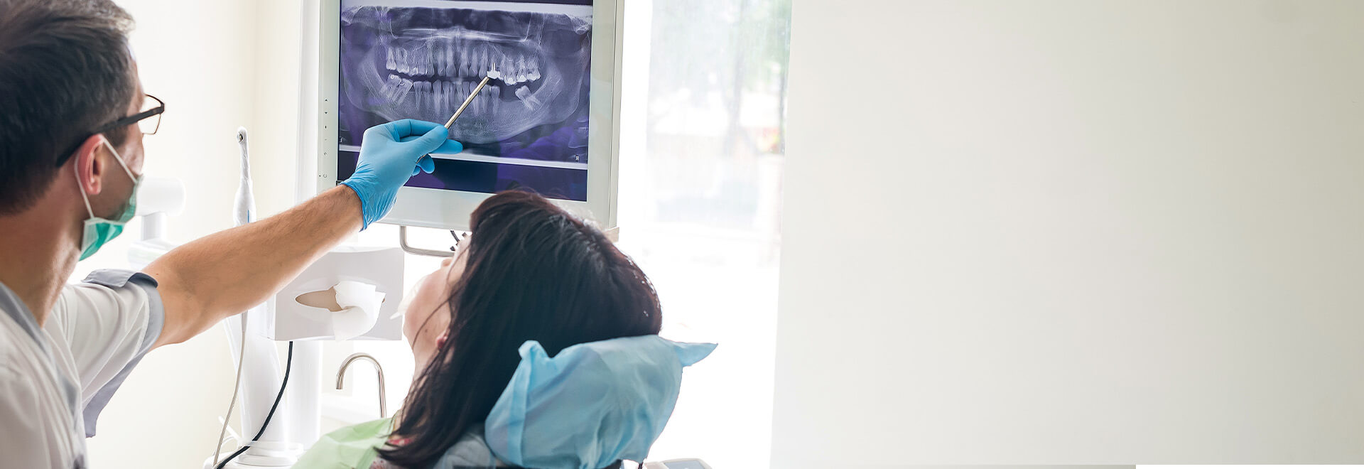 woman looking at her xrays with dentist