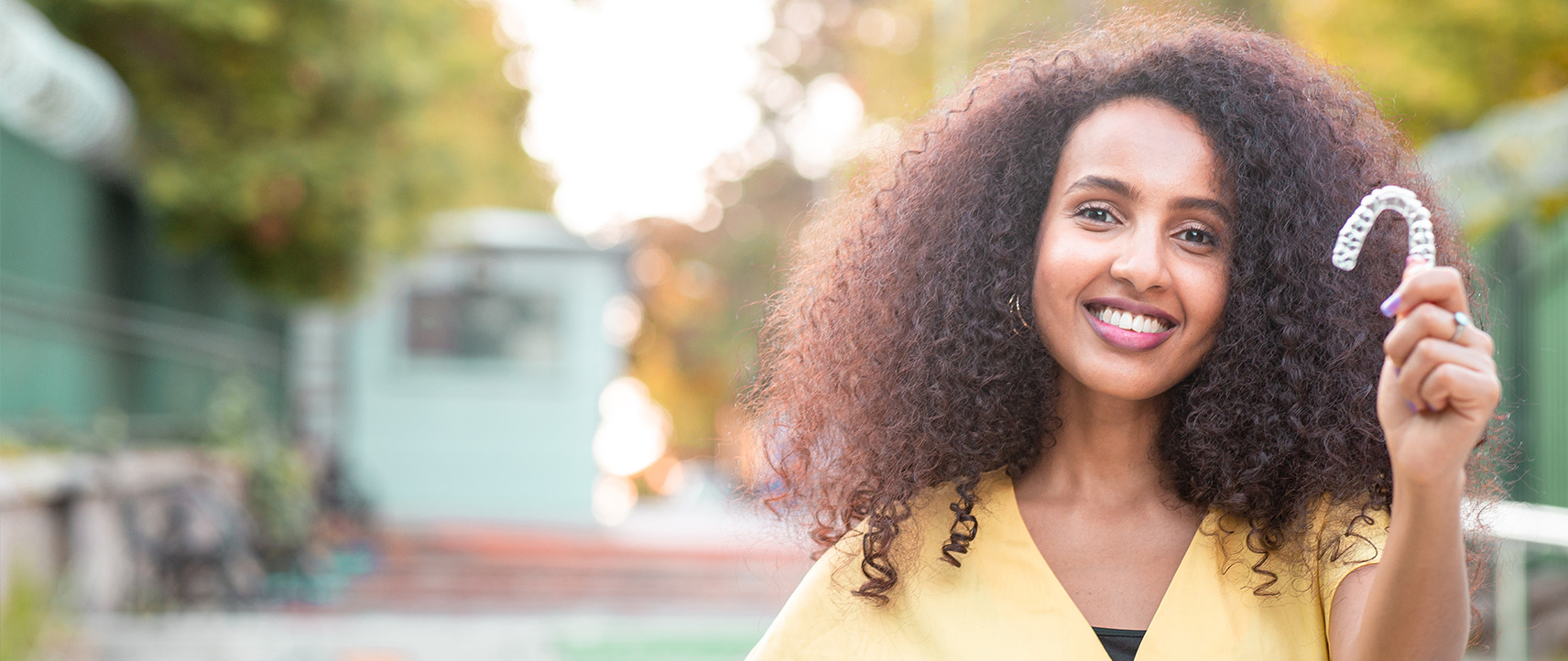 woman holding invisalign
