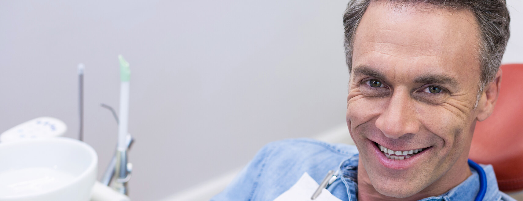 man smiling at the dentist